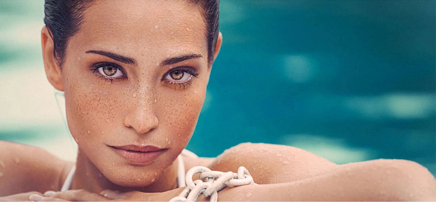 Woman posing on side of pool